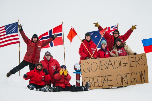 UW–Madison IceCube Laboratory researchers hold a sign that reads